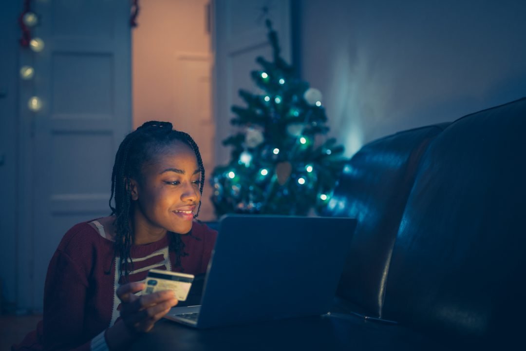 African women shopping Christmas presents online at home